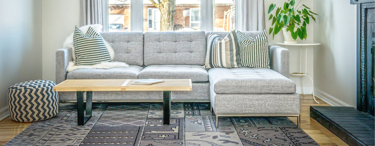 Taxim Convertible Chaise Sectional by SohoConcept, showing front view of taxim convertible chaise sectional with table in live shot.