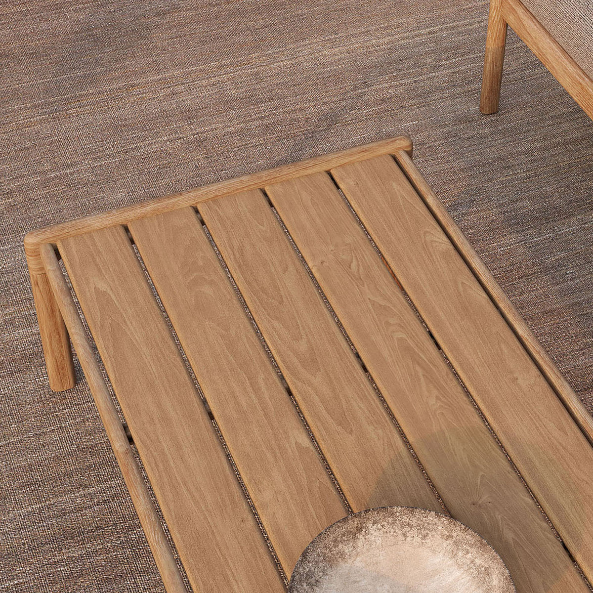 Jack Outdoor Coffee Table by Ethnicraft , showing closeup view of teak outdoor coffee table in live shot.