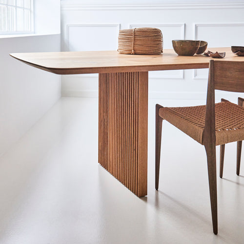Ten Dining Table by DK3, showing dining table with chair in live shot.
