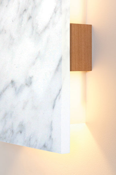 Tersus LED Sconce by Cerno, showing closeup view of tersus walnut wood/carrara marble led sconce in live shot.