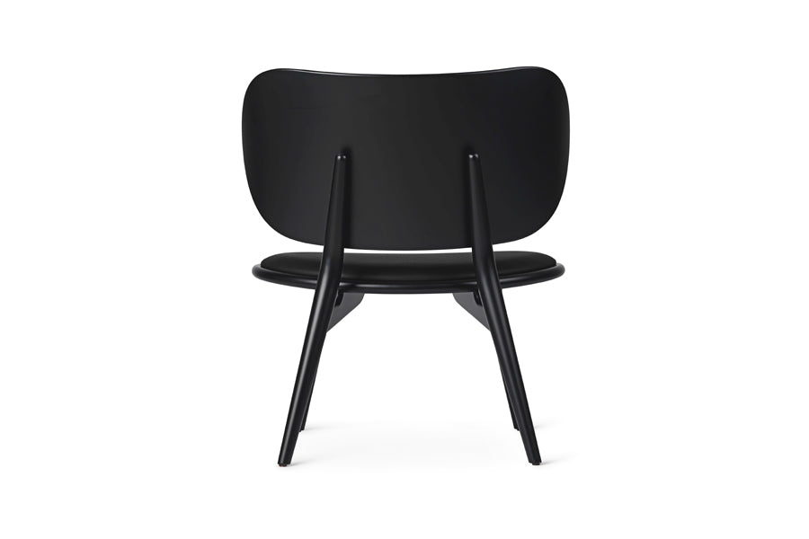 The Lounge Chair by Mater, showing back view of the lounge chair in black stained beech wood/black leather seat.