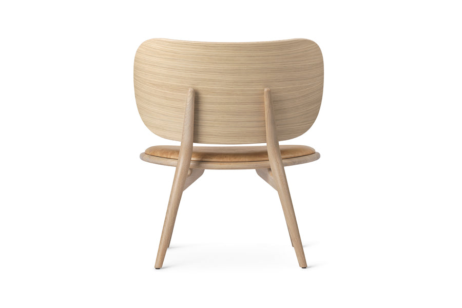 The Lounge Chair by Mater, showing back view of the lounge chair in natural matt lacqured oak/natural tanned leather seat.