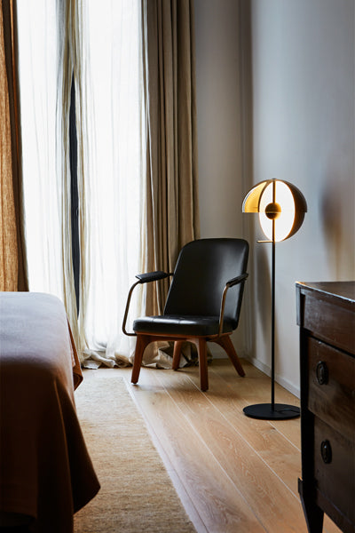 Theia Floor Lamp by Marset, showing angle view of black floor lamp in live shot.