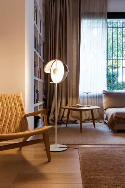 Theia Floor Lamp by Marset, showing angle view of white floor lamp in live shoot.