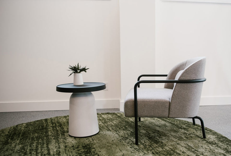Thick Top Side Table by Toou, showing thick top side table with chair in live shot.