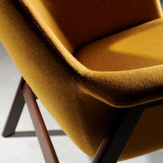 To Be Wood Lounge Chair by B&T, showing closeup view of to be wood lounge chair in live shot.