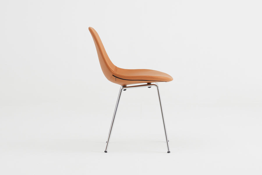TA Upholstered Side Chair Er by Toou, showing side view of ta upholstered side chair er in chrome base, cognac pu shell seat.