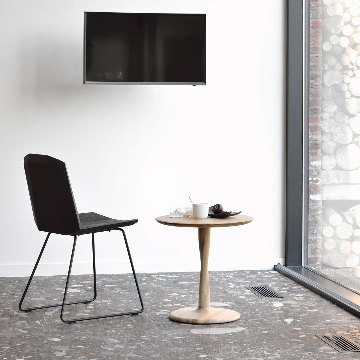 Torsion Dining Table by Ethnicraft, showing torsion dining table in live shot.