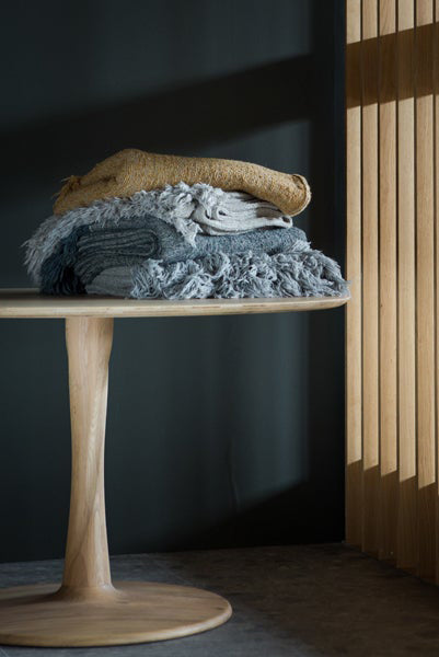 Torsion Dining Table by Ethnicraft, showing closeup view of torsion dining table in live shot.