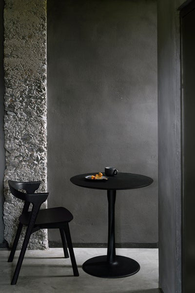 Torsion Dining Table by Ethnicraft, showing torsion dining table in live shot.