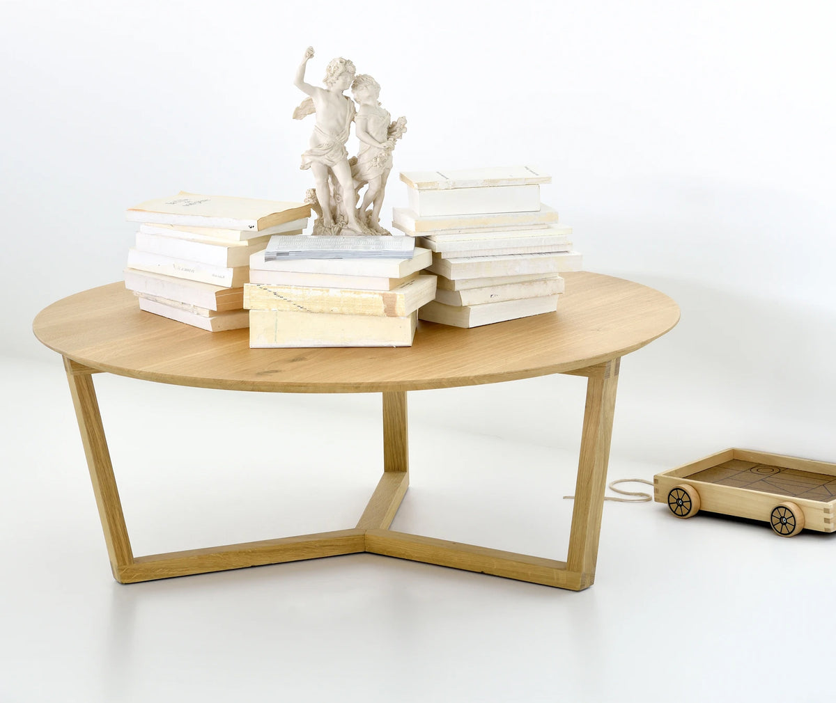 Tripod Coffee Table by Ethnicraft, showing front view of oak coffee table in the live shot.