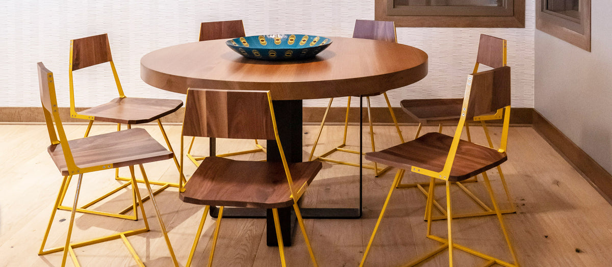 Clarkester Chair by Tronk Design, showing front view of clarkester chair with table in live shot.