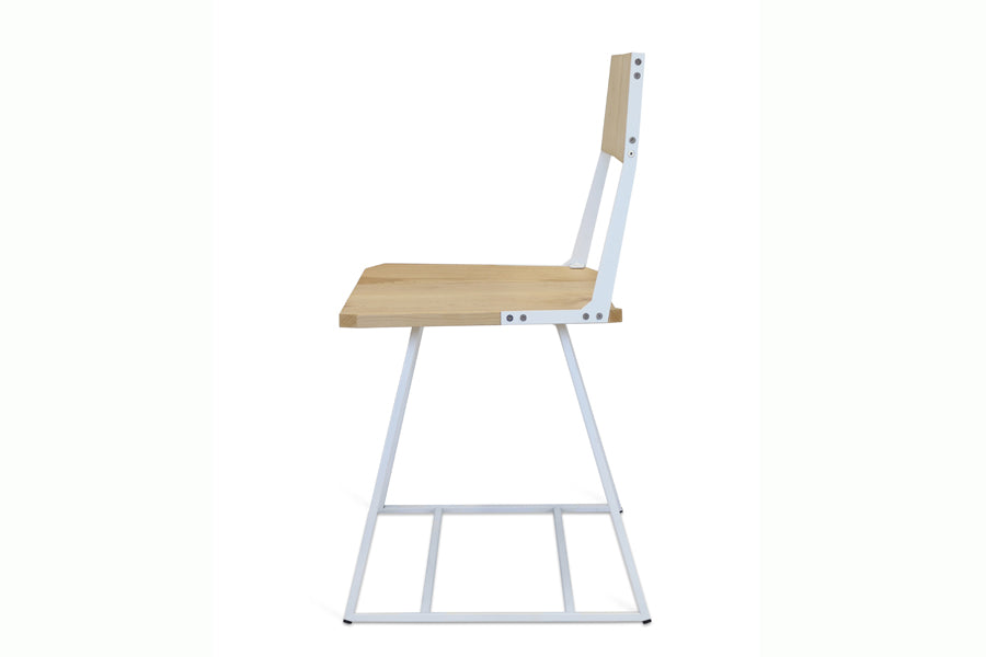 Clarkester Chair by Tronk Design, showing side view of clarkester chair in maple wood, white powder coated steel.