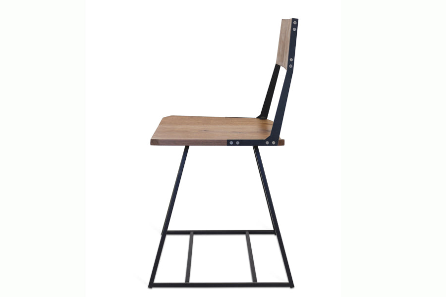Clarkester Chair by Tronk Design, showing side view of clarkester chair in walnut wood, black powder coated steel.