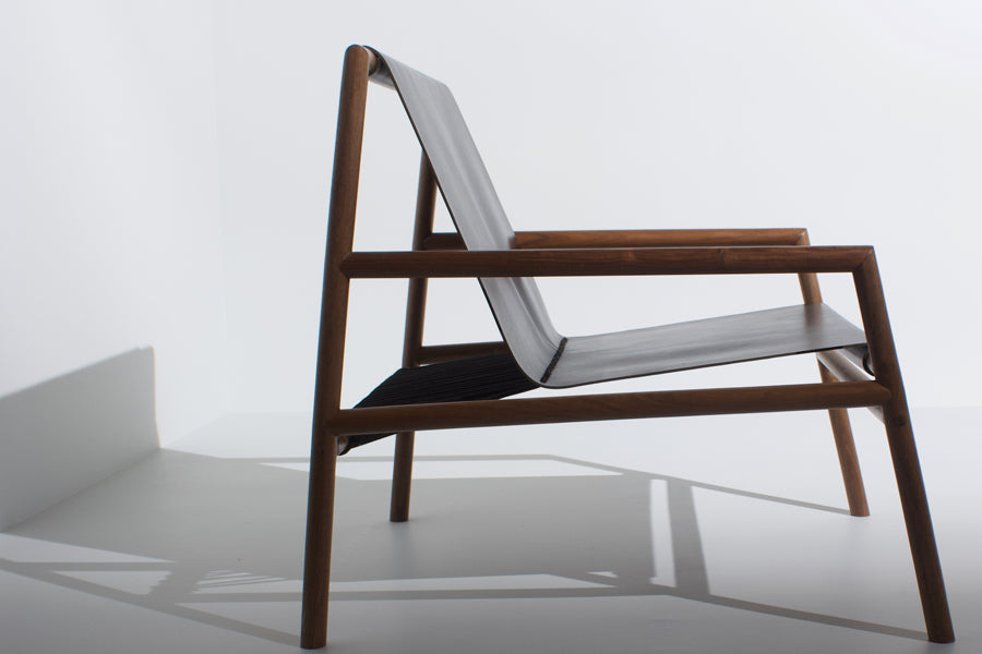 Gallagher Lounge Chair by Tronk Design, showing side view of gallagher lounge chair in live shot.