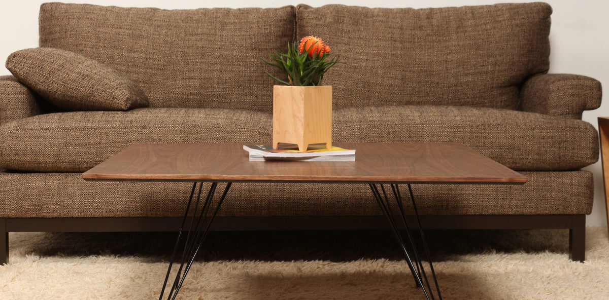 Williams Square Coffee Table by Tronk Design, showing williams square coffee table with sofa in live shot.