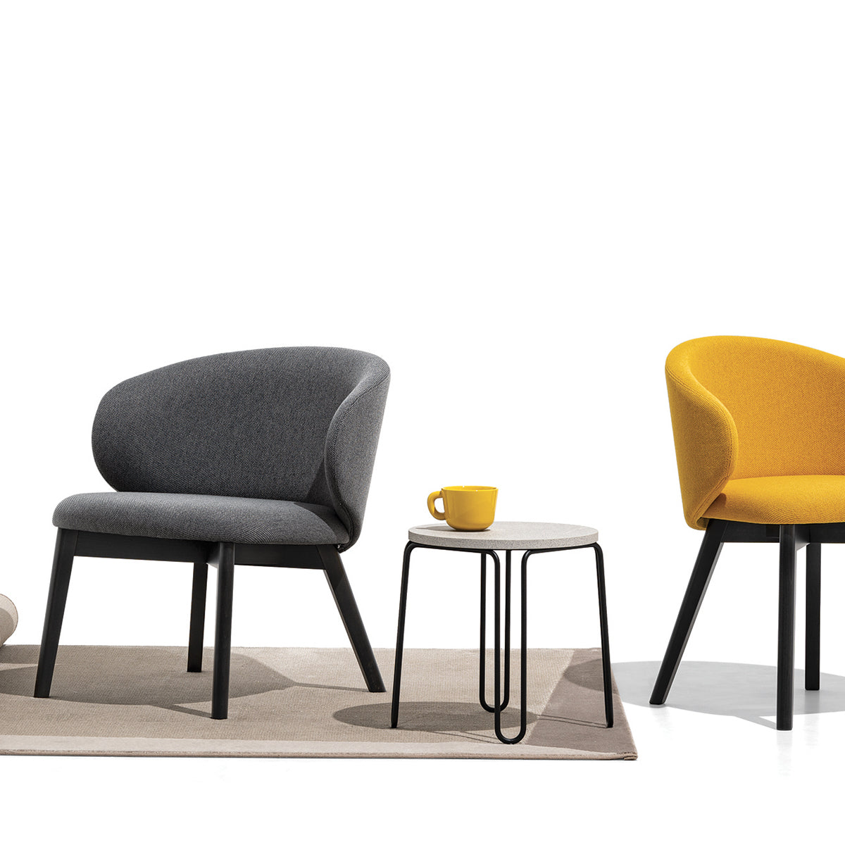 Tuka Wood Legs Armchair by Connubia, showing closeup view of tuka wood legs armchair in graphite beechwood frame.