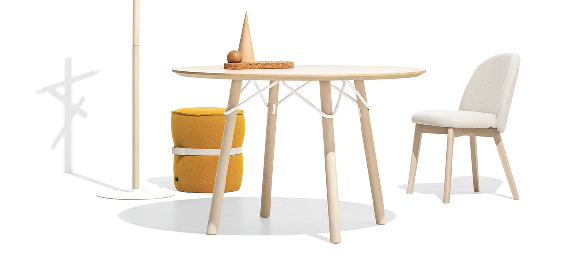Tuka Wood Legs Chair by Connubia, showing angle view of tuka wood legs chair with stool/table.