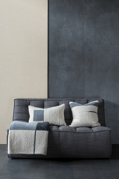 Urban Cushion by Ethnicraft, showing front view of urban cushions with throw in live shot.