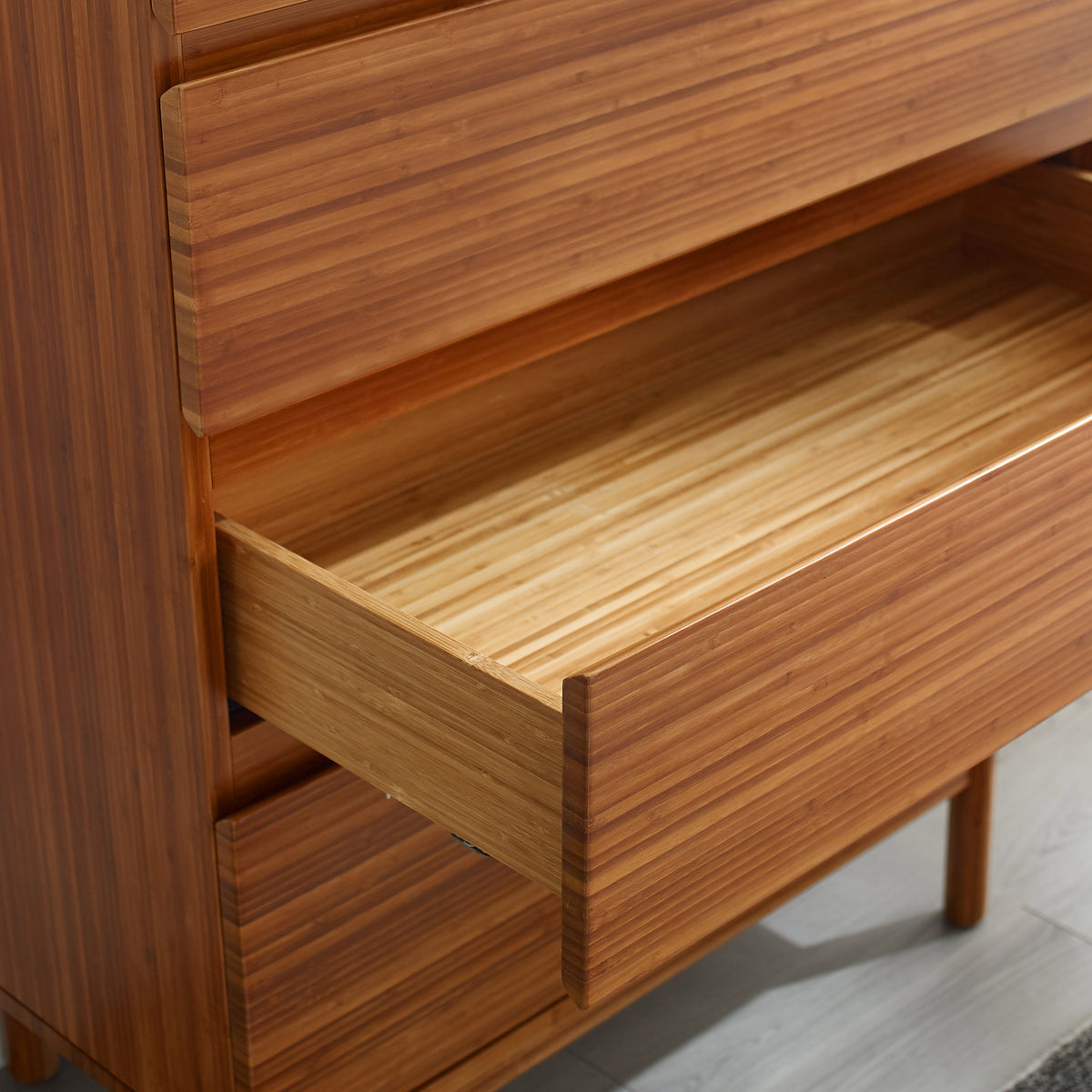 Ventura Amber 4 Drawer High Chest by Greenington, showing closeup view of ventura amber 4 drawer high chest in live shot.