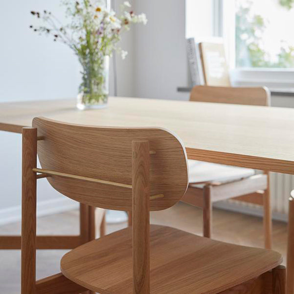 Vester Dining Chair by Skagerak, showing closeup view of vester dining chairs in live shot.