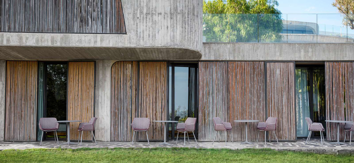 Vibe Outdoor Dining Chair by Cane-Line, showing vibe outdoor dining chairs with tables in live shot.