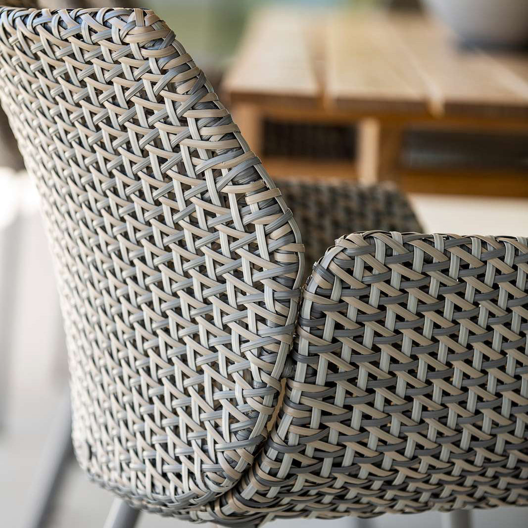 Vibe Outdoor Dining Chair by Cane-Line, showing closeup view of vibe outdoor dining chair in live shot.