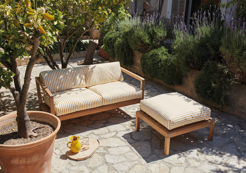 Virkelyst 2-Seater Sofa by Skagerak, showing virkelyst sofa with pouf in live shot.