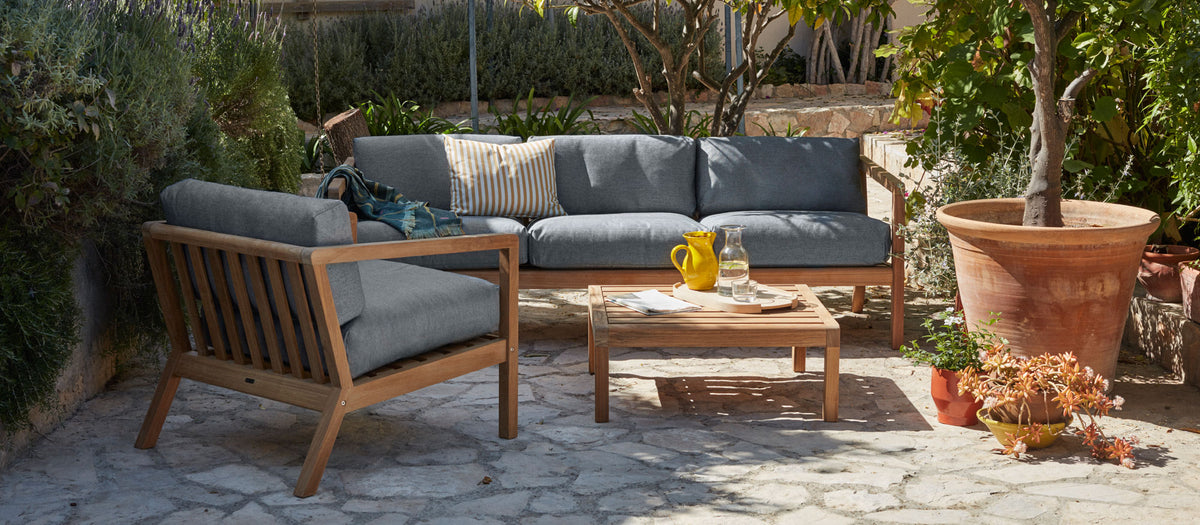 Virkelyst 3-Seater Sofa by Skagerak, showing virkelyst 3-seater sofa with table & chair in live shot.