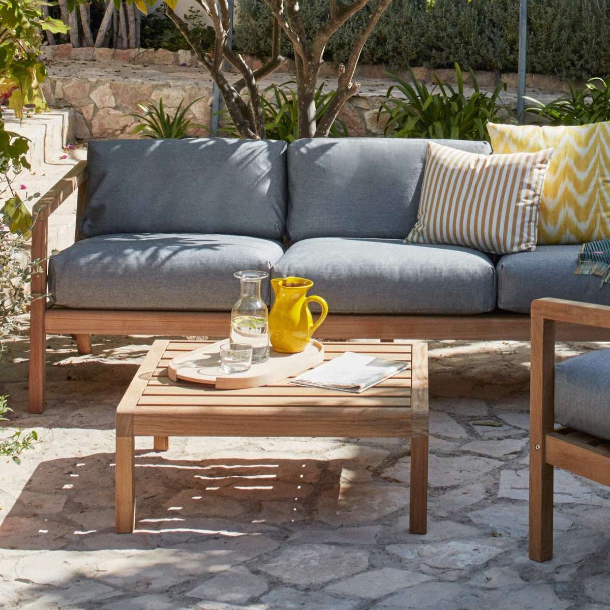 Virkelyst 3-Seater Sofa by Skagerak, showing virkelyst 3-seater sofa with table & chair in live shot.