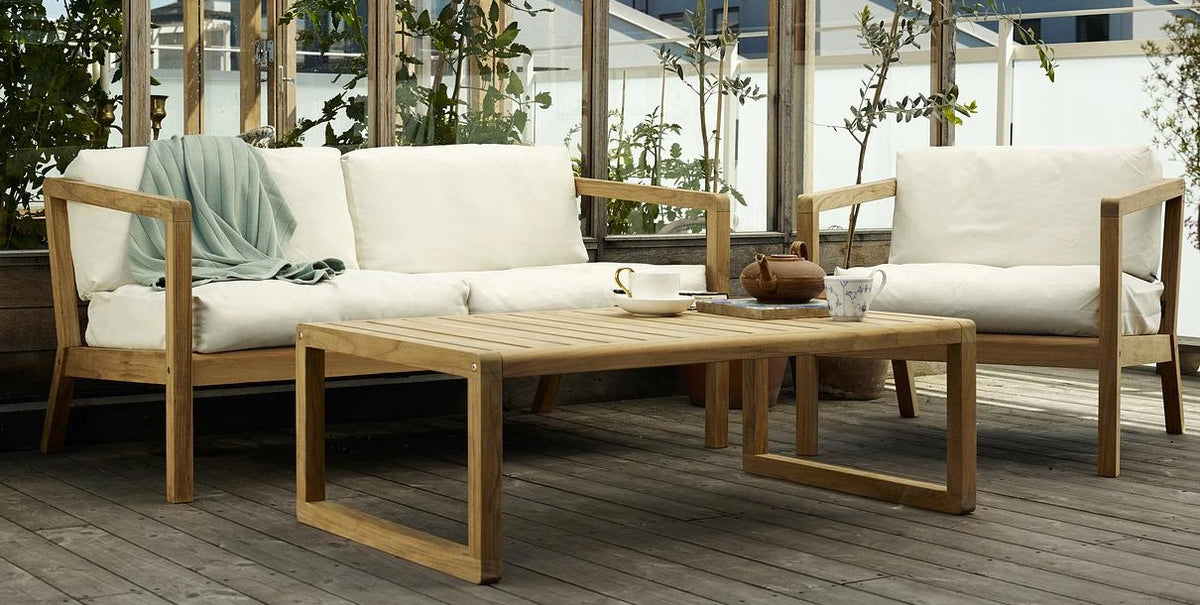 Virkelyst Coffee Table by Skagerak, showing virkelyst coffee table with sofa & chair in live shot.