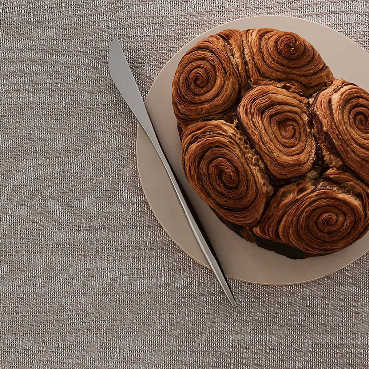 Woodgrain Placemat by Chilewich, showing woodgrain placemat in live shot.