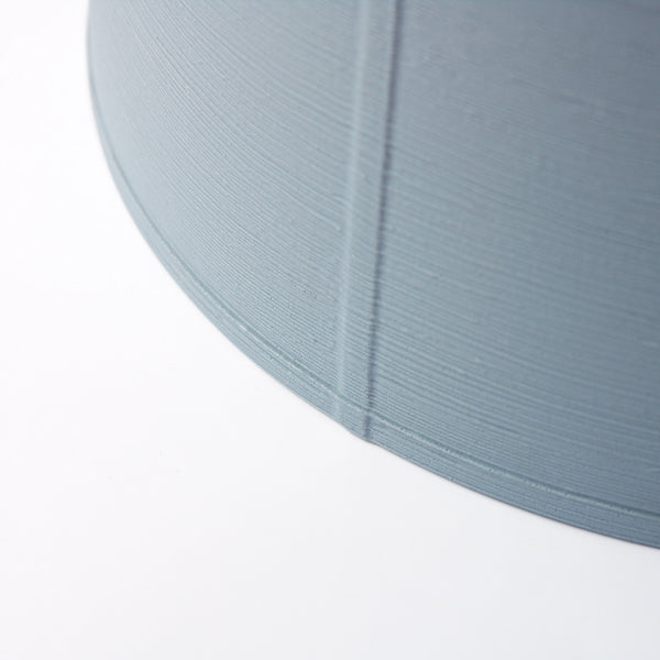 Zenc Pendant by Marset, showing closeup view of zenc pendant in sky blue polyethylene shade.
