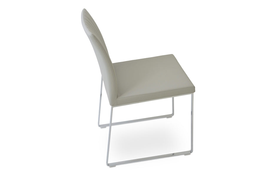 Zeyno Sled Chair by sohoConcept, showing angle view in light grey leatherette.