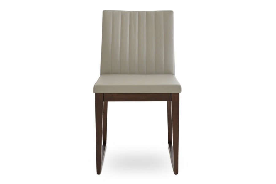 Zeyno Sled Wood Chair by sohoConcept, showing front view in light grey leatherette with walnut finish base.